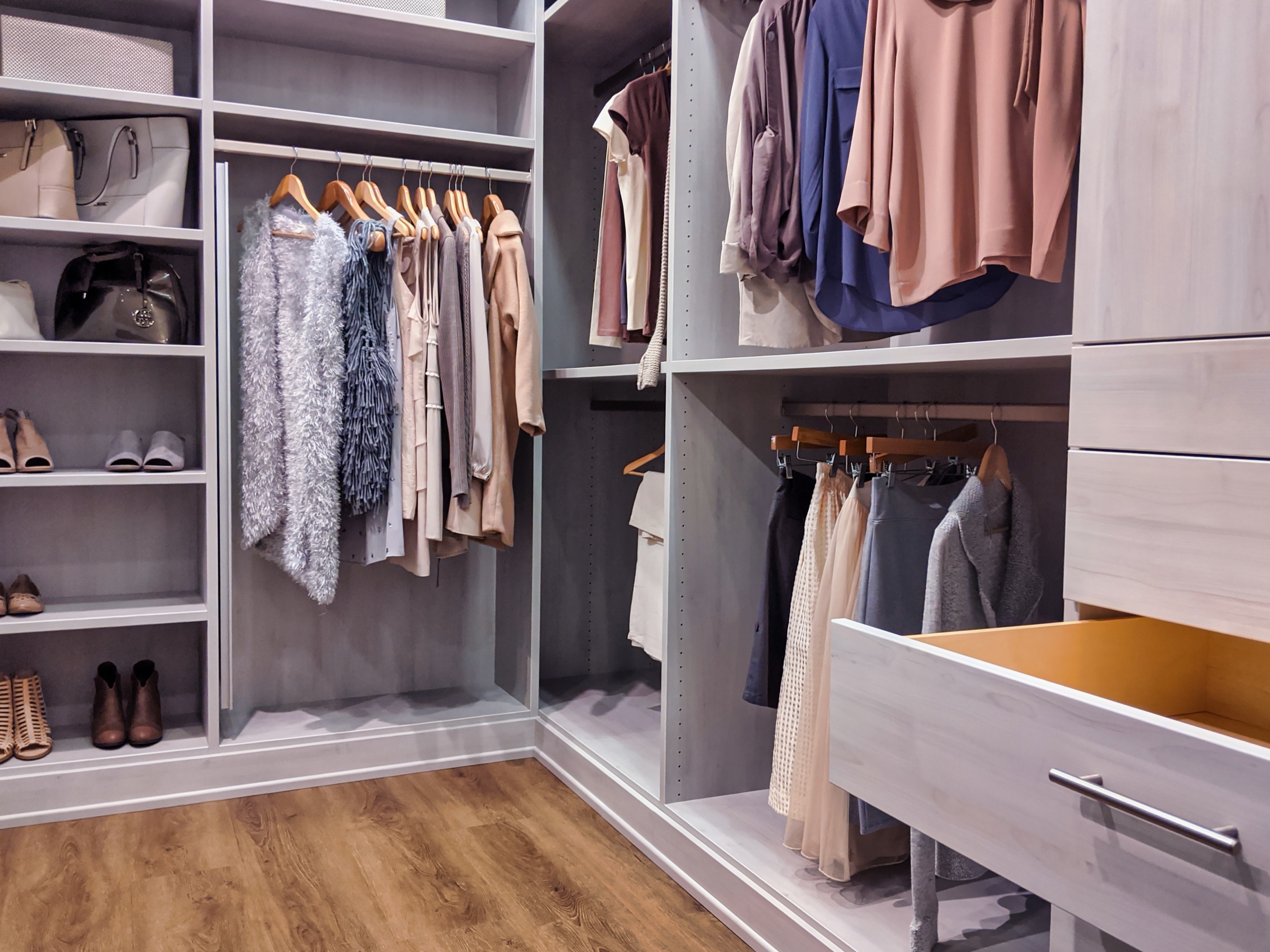 Modern walk-in closet in light gray oak finish with cashmere display — luxury details that international buyers expect
