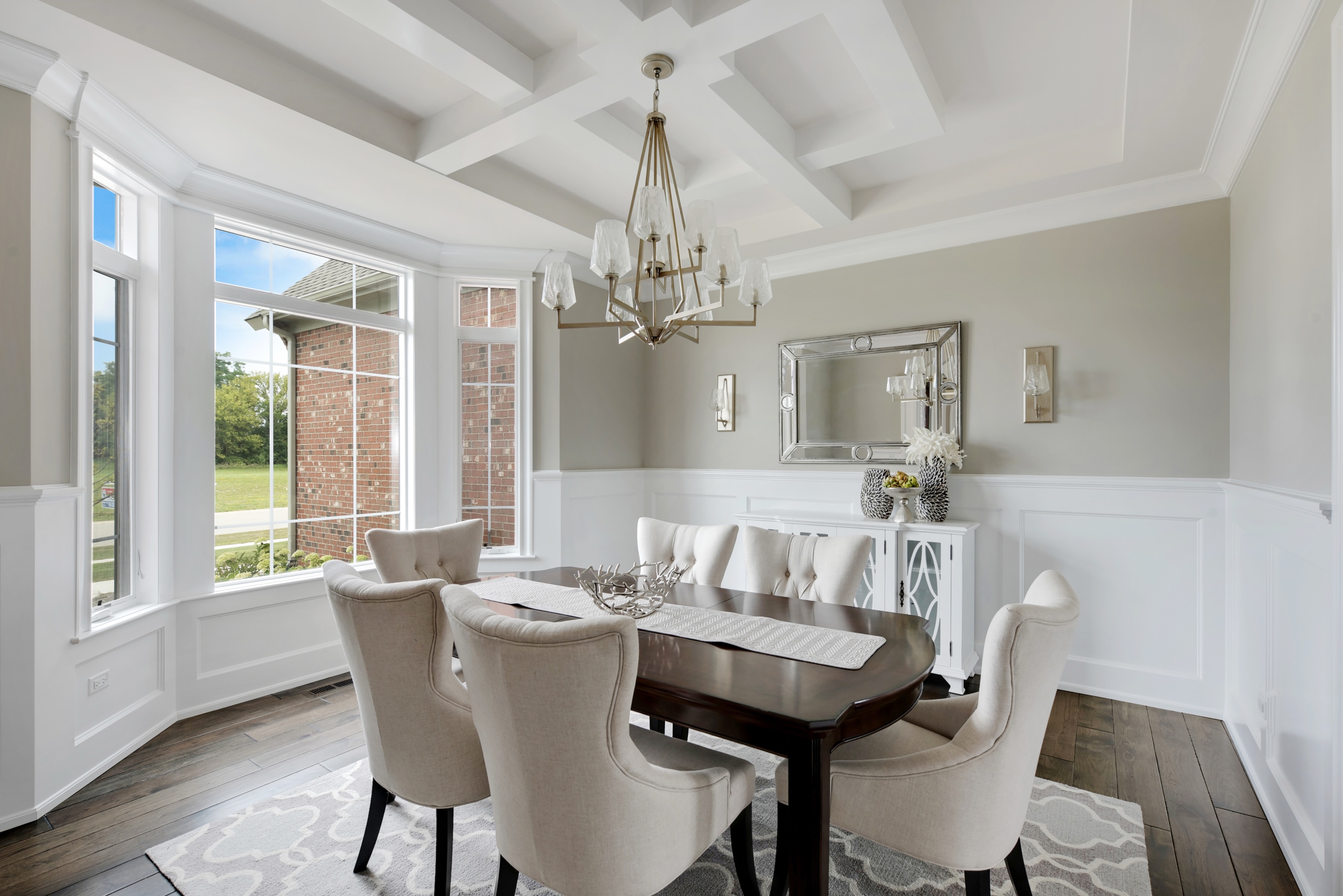 Formal dining room with white coffered ceiling and bay window view — the spaces that anchor a Listing Concierge Luxe marketing package
