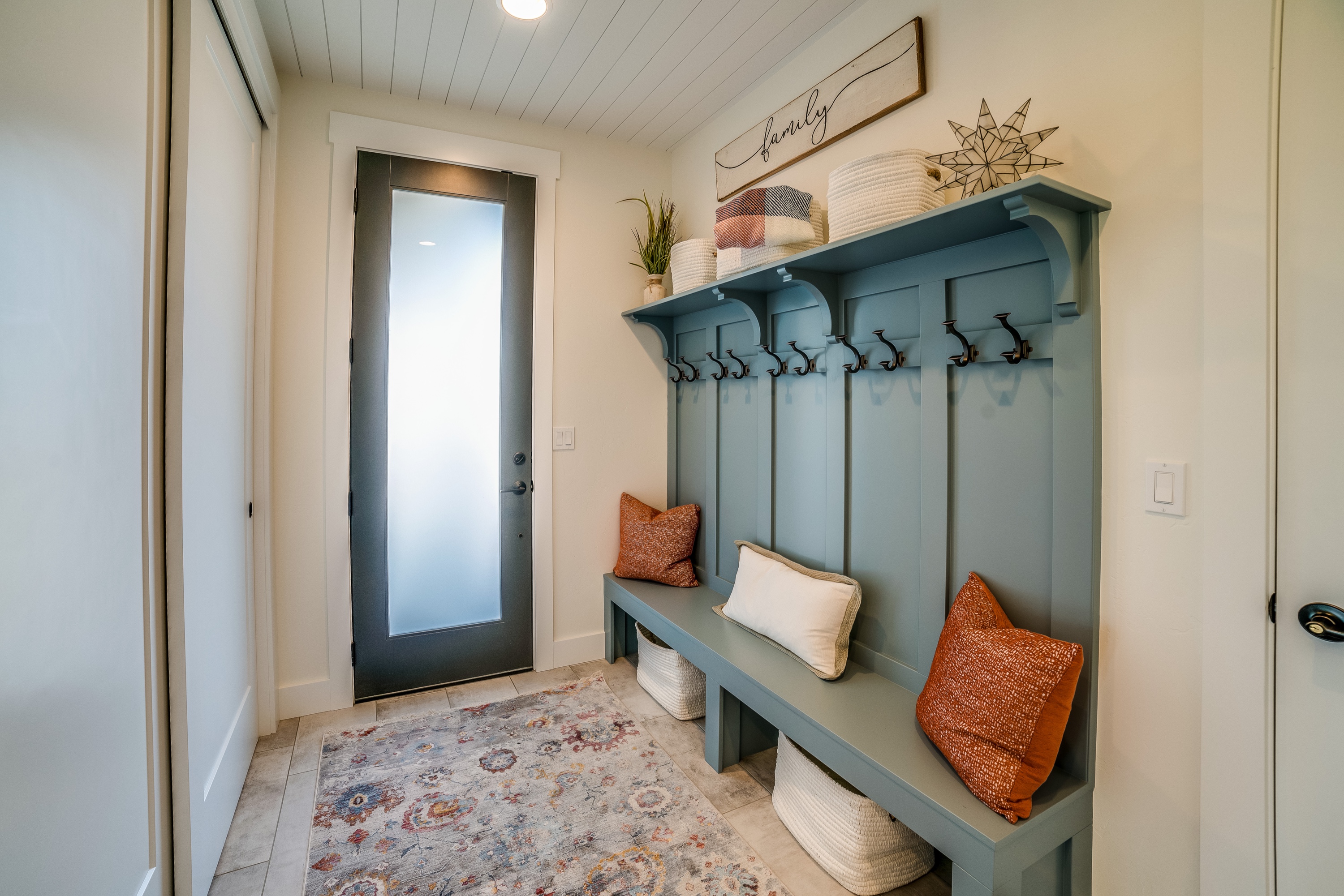 Staged entry bench and mudroom detail in a prepared home