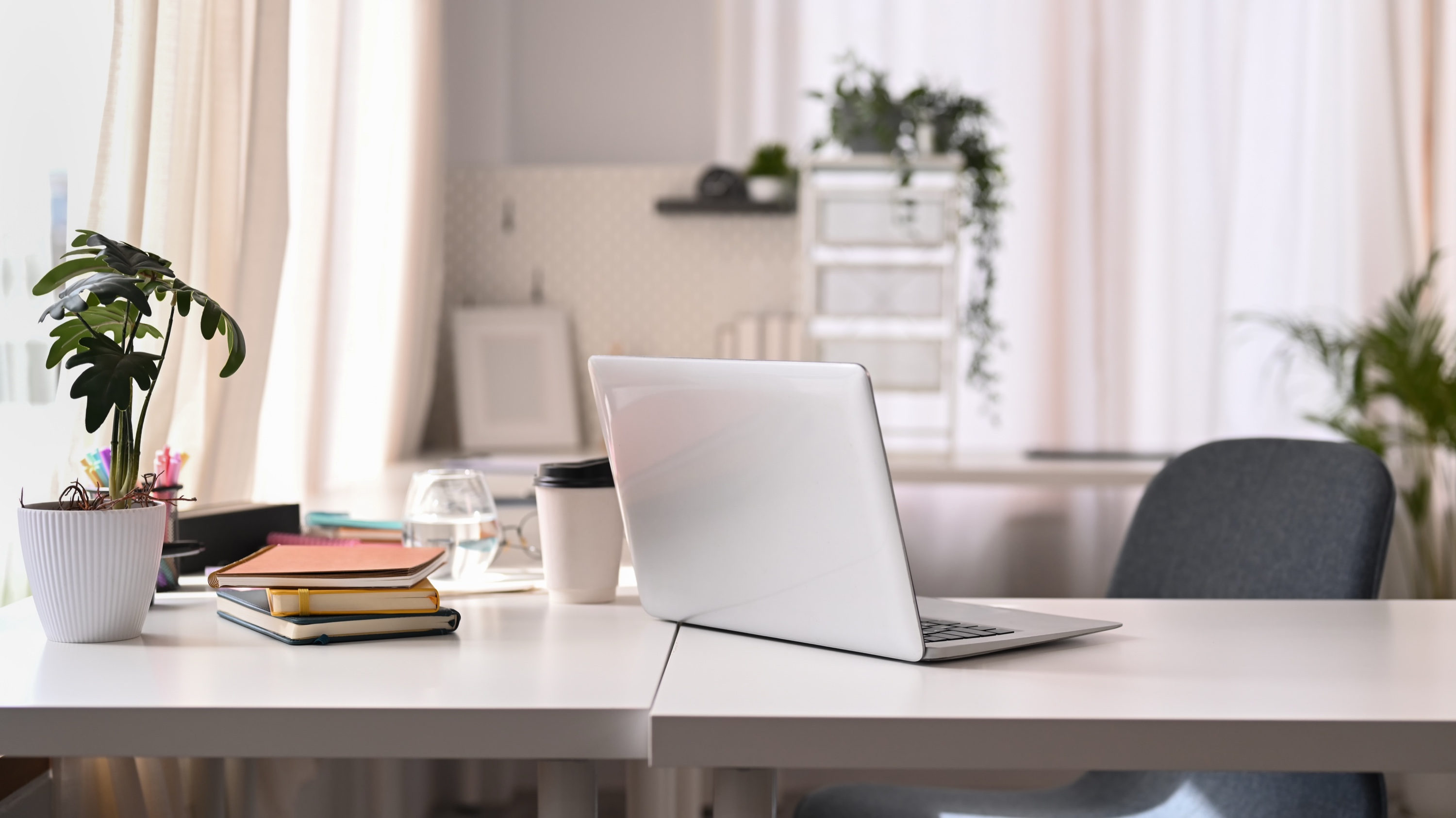 Bright modern home office with laptop, where an investor runs total-return numbers