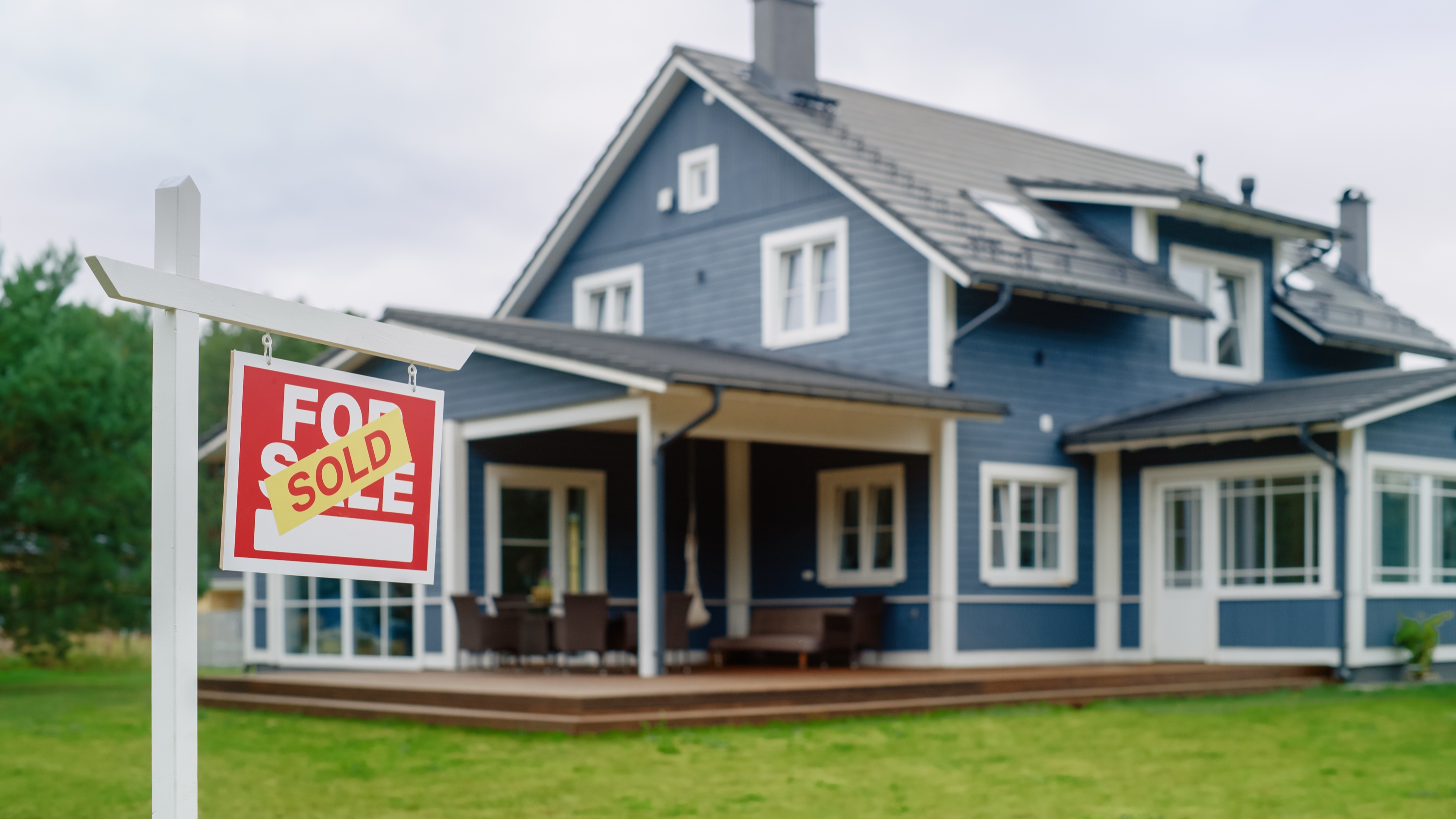 Red SOLD property sign in front of a Silicon Valley home — fast home sale