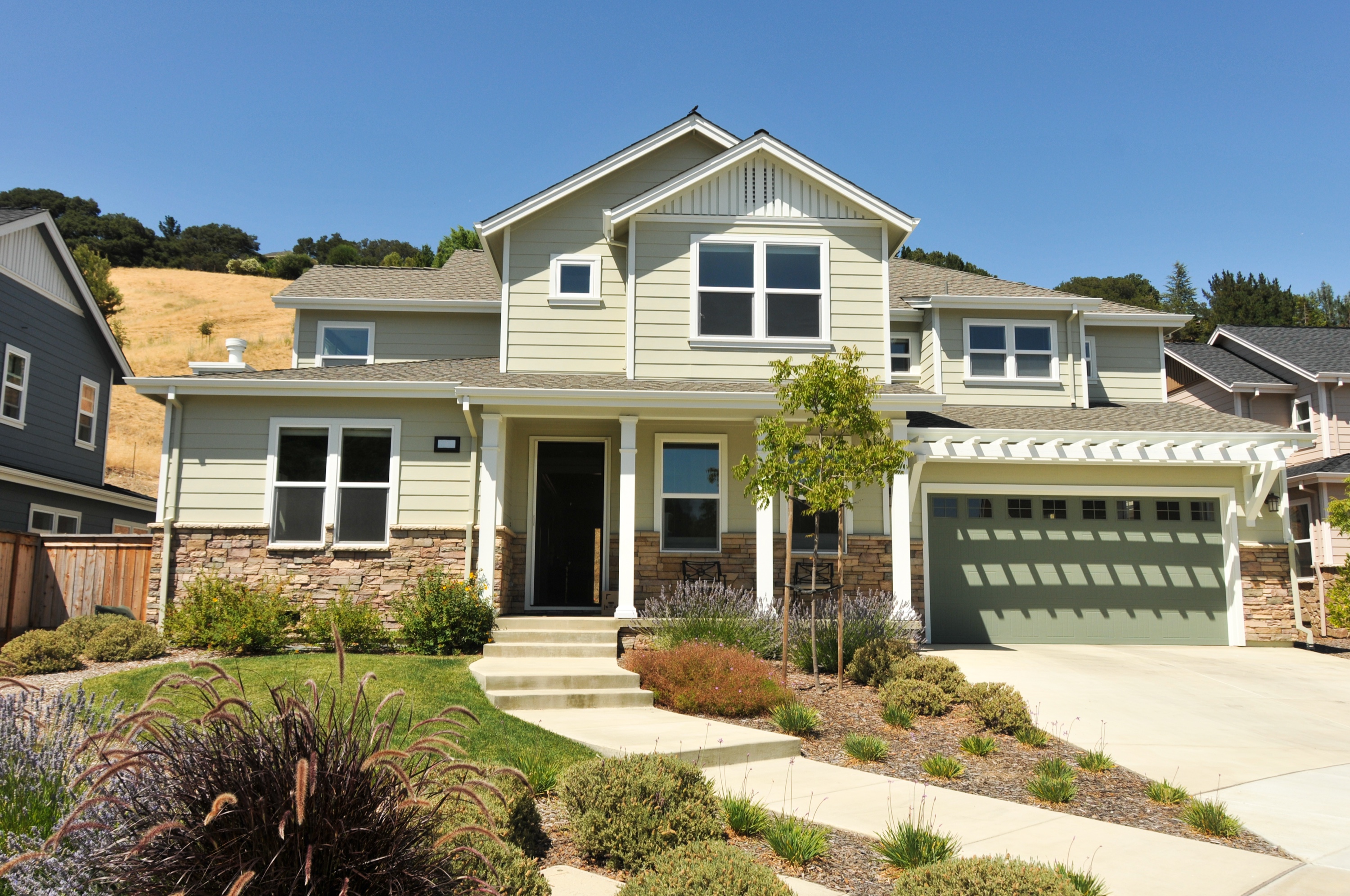 A two-story single-family home with a driveway on a quiet residential street