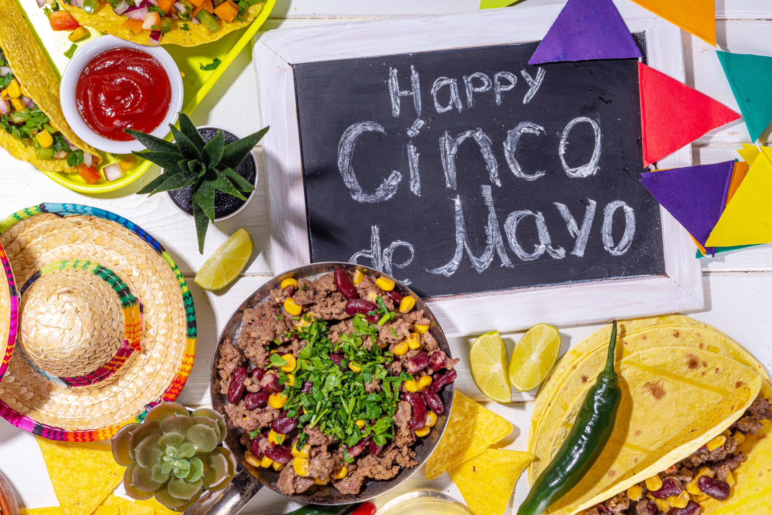 Colorful Cinco de Mayo party food spread with tacos and traditional Mexican dishes