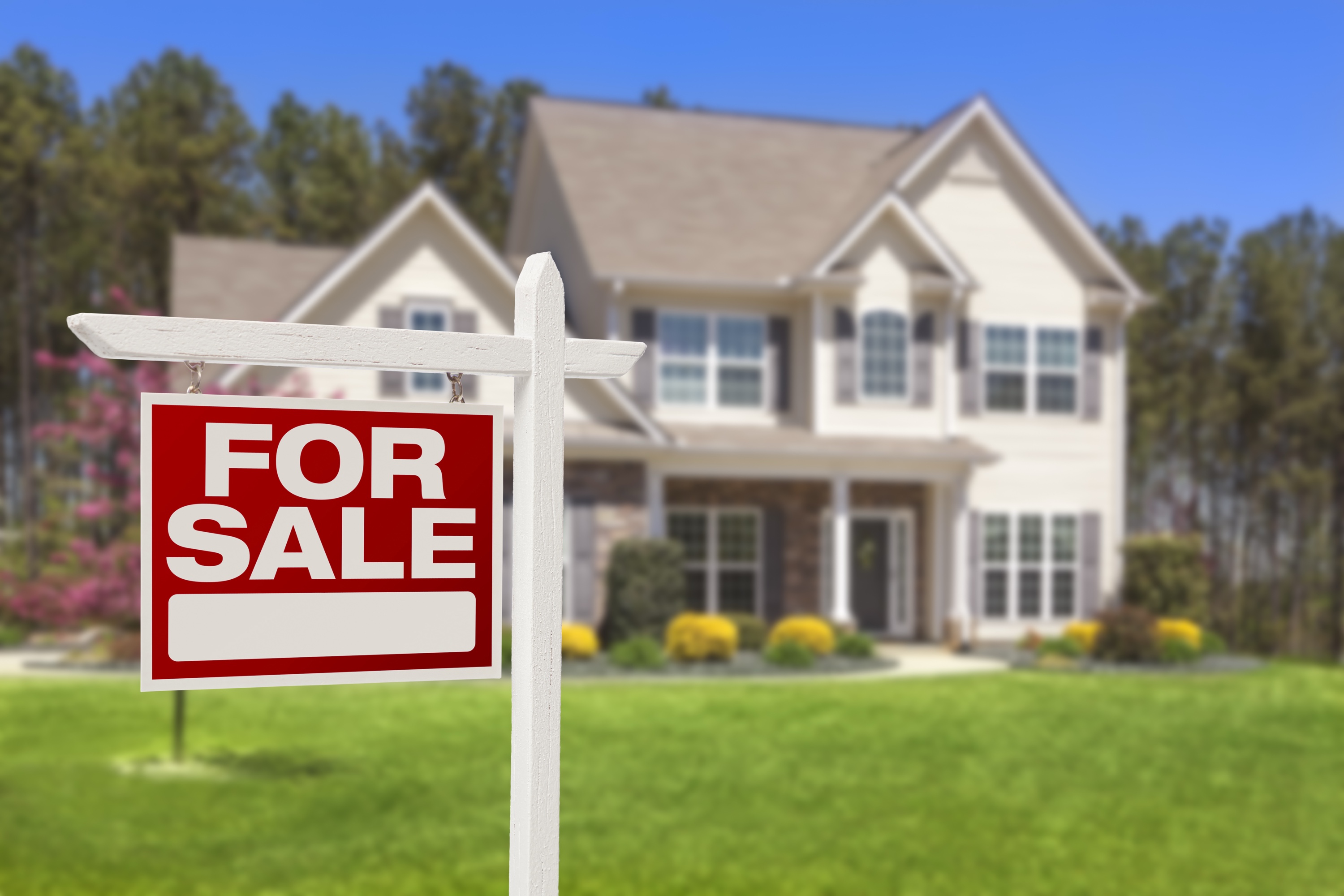 Real estate for-sale sign in front of a house