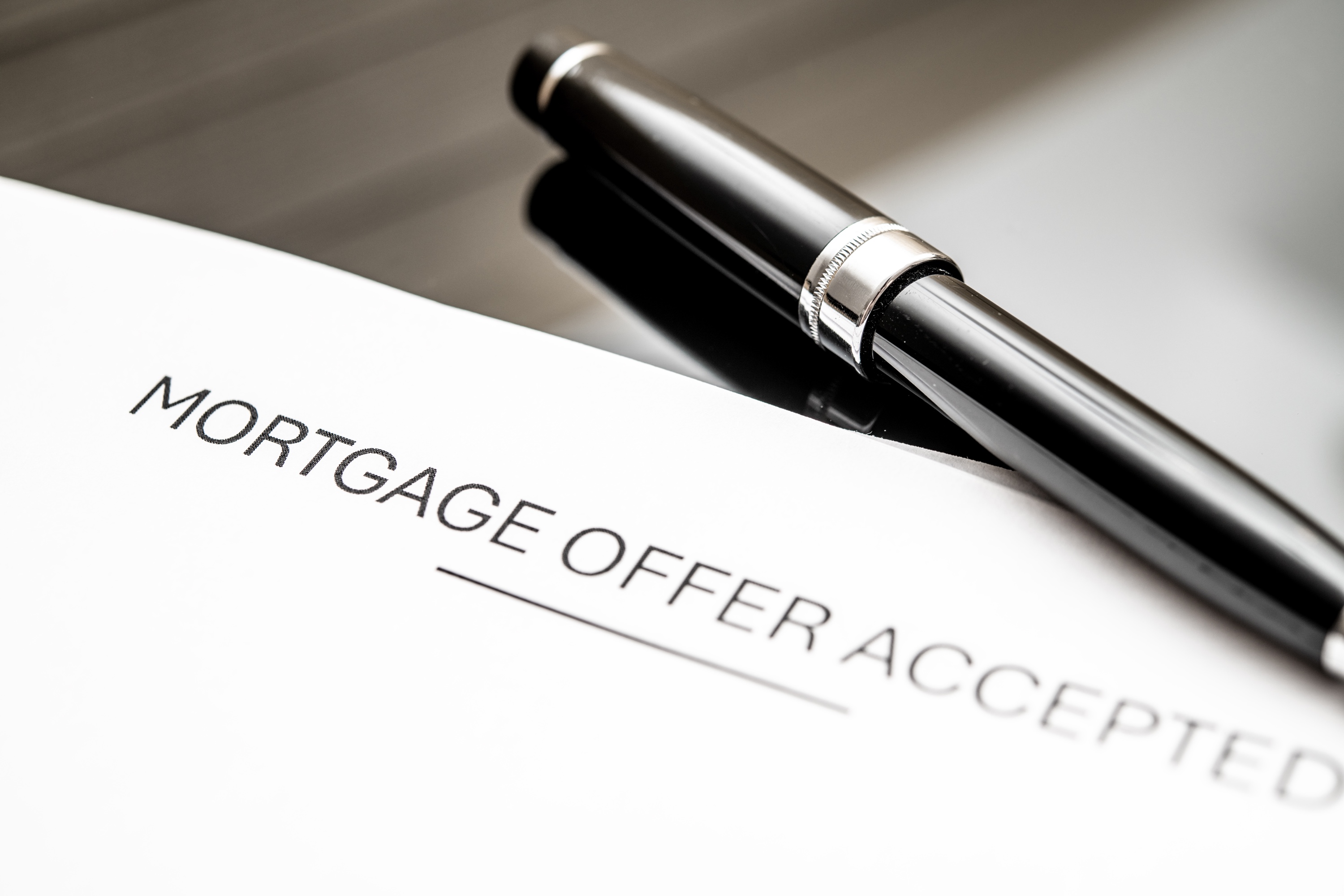 Mortgage offer accepted document with elegant pen on a modern desk representing a fully underwritten Silicon Valley pre-approval