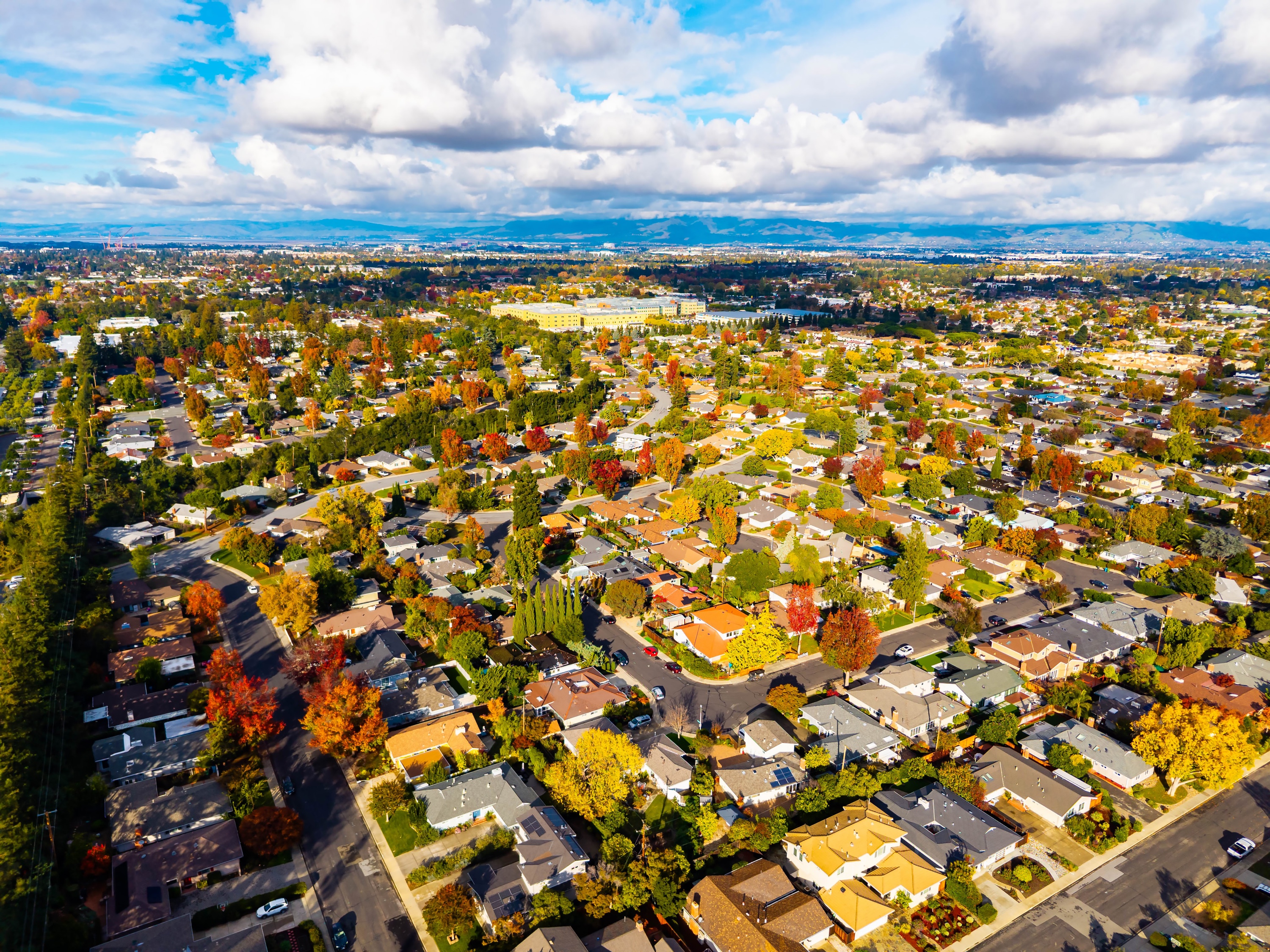 Aerial cityscape view of Cupertino, California with surrounding hills