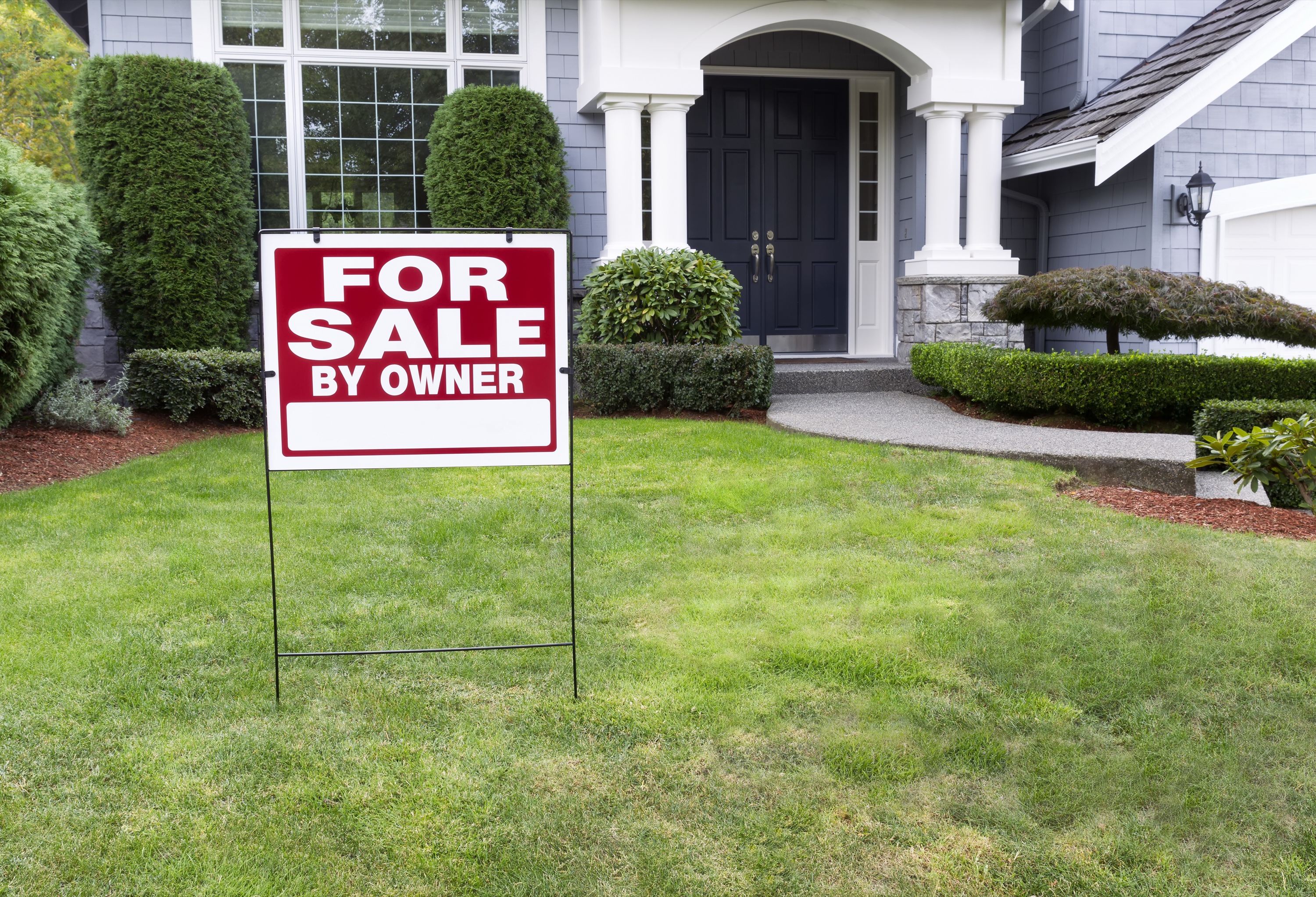 Modern home with a for-sale sign in the front yard in Silicon Valley
